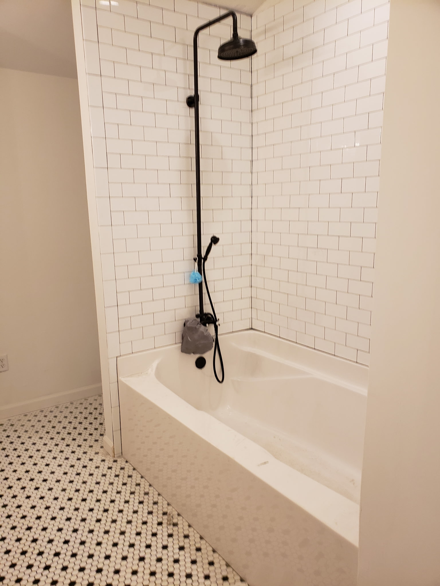 Tankless water heater installed on a brick exterior wall