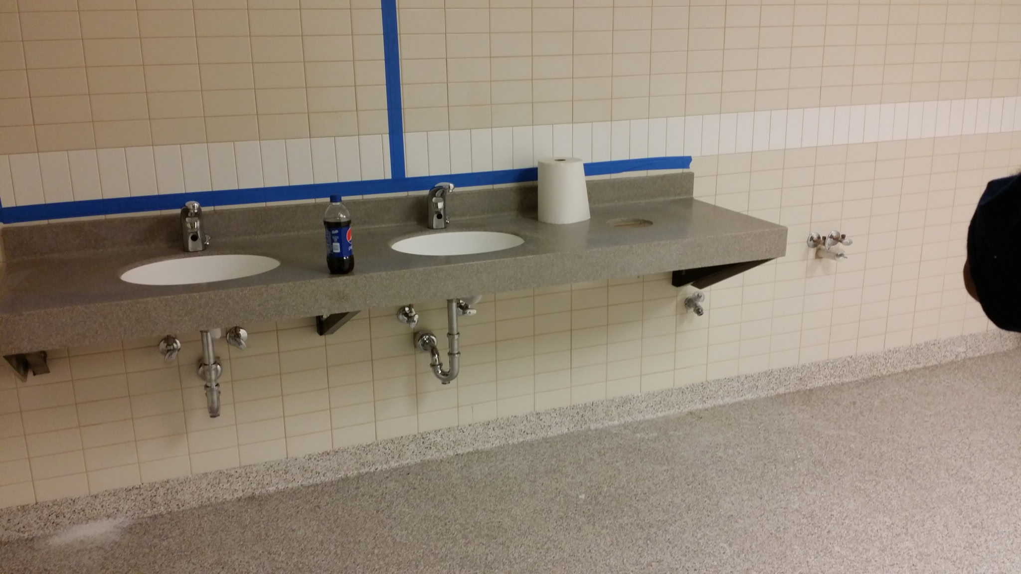 Commercial restroom vanity with undermount sinks and chrome faucets