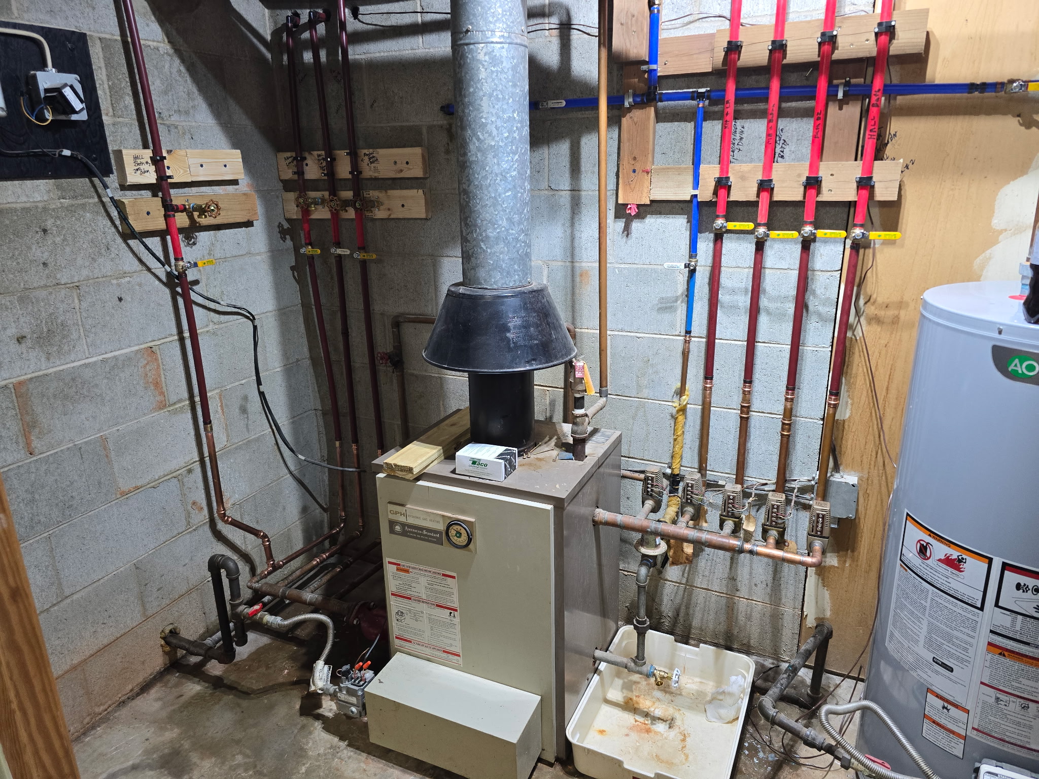 Residential boiler and PEX manifold installation in a mechanical room