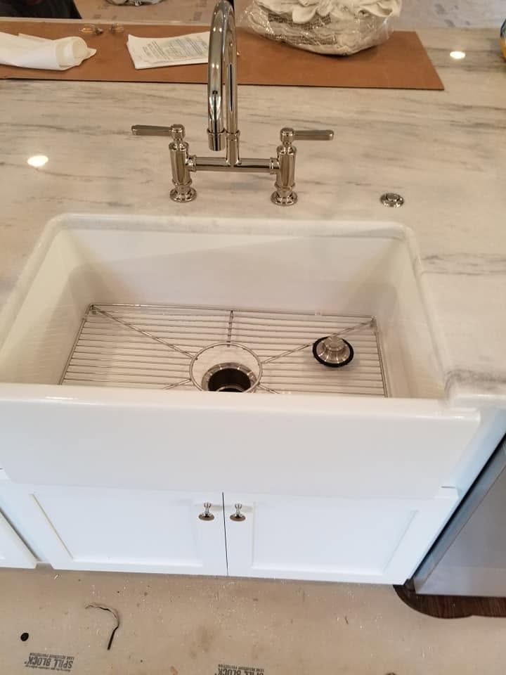 Farmhouse sink and bridge faucet during a kitchen remodel